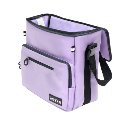 Angled view of Light purple coloured, rectangular bag, with 2 reflective tags, Shows 1 main compartment, with flip top open. Buddy-z adaptable tote bag is Convertible between mobility aid bag, Wheelchair backpack, and crossbody bag, with special attachments.